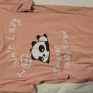 It's a medium, salmon colored panda saying shirt from On Fire.
